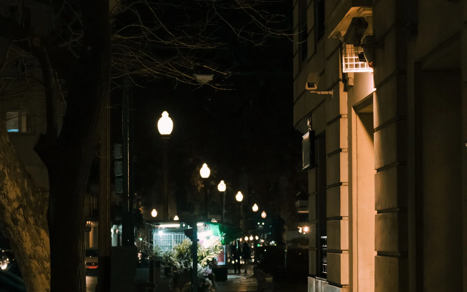 A quiet pedestrian street in central Buenos Aires at night, lit by streetlamps